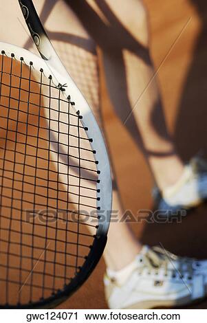 Low section view of a person with a tennis racket View Large Photo Image Stock Image - Low section view of a person with a tennis racket. Fotosearch