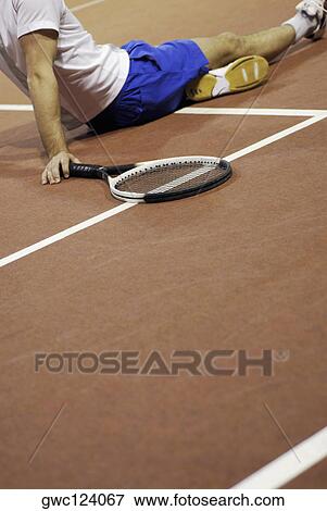 Side profile of a man sitting on a tennis court View Large Photo Image Stock Photo - Side profile of a man sitting on a tennis court. Fotosearch