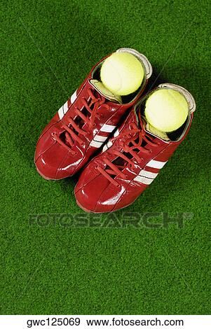 Close-up of a pair of sports shoes with tennis balls View Large Photo Image Stock Photo - Close-up of a pair of sports shoes with tennis balls. Fotosearch