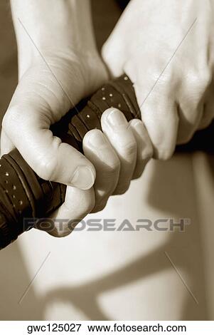 Close-up of a person's hand holding a tennis racket View Large Photo Image Stock Photo - Close-up of a person's hand holding a tennis racket. Fotosearch