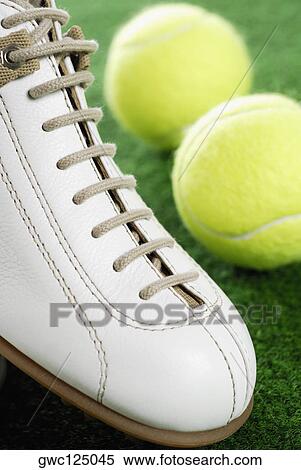 Close-up of a sports shoe and two tennis balls View Large Photo Image Stock Photography - Close-up of a sports shoe and two tennis balls. Fotosearch