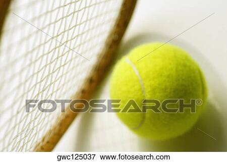 Stock Photo - Close-up of a tennis ball and a tennis racket. Fotosearch