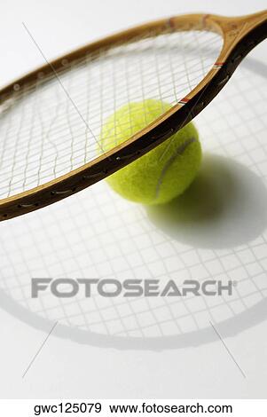Stock Photo - Close-up of a tennis ball and a tennis racket. Fotosearch