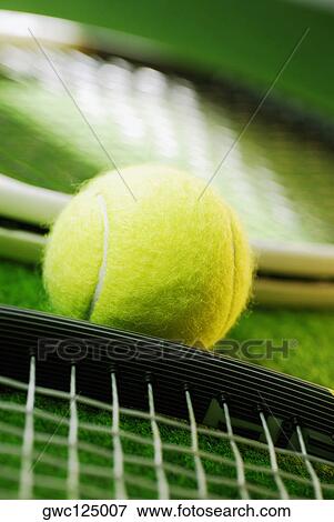 Stock Photo - Close-up of a tennis ball and two tennis rackets. Fotosearch