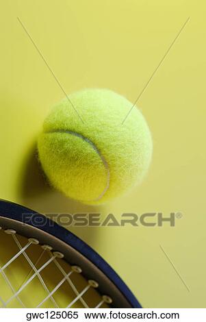 Stock Photography - Close-up of a tennis ball with a tennis racket. Fotosearch