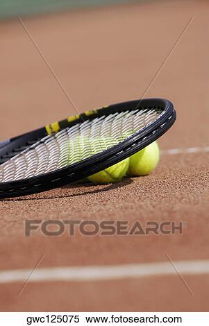 Close-up of a tennis racket and three tennis balls on a tennis court View Large Photo Image Stock Photography - Close-up of a tennis racket and three tennis balls on a tennis court. Fotosearch