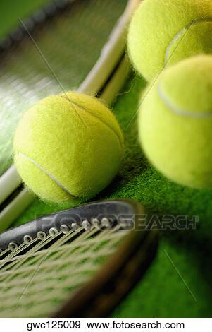 Close-up of three tennis balls and two tennis rackets View Large Photo Image Stock Photo - Close-up of three tennis balls and two tennis rackets. Fotosearch