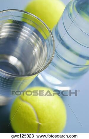 High angle view of a glass of water with a water bottle and two tennis balls View Large Photo Image Stock Image - High angle view of a glass of water with a water bottle and two tennis balls. Fotosearch