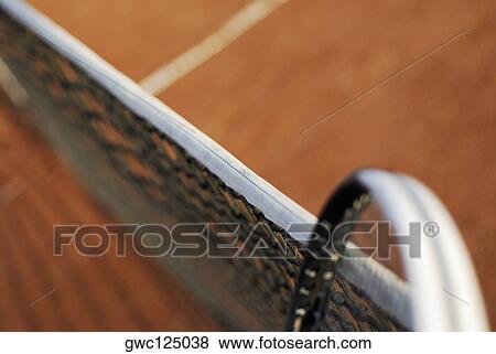 Stock Photo - High angle view of a tennis racket and a tennis net on a tennis court. Fotosearch