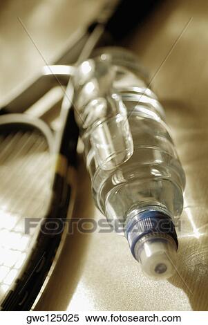 Stock Photography - High angle view of a tennis racket and a water bottle. Fotosearch