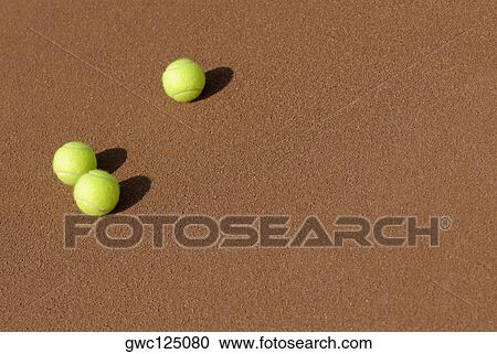 Stock Image - High angle view of three tennis balls. Fotosearch