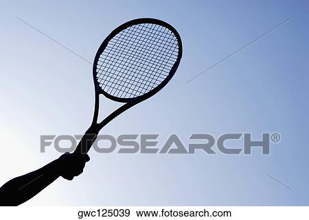 Low angle view of a person's hand holding a tennis racket View Large Photo Image Stock Photo - Low angle view of a person's hand holding a tennis racket. Fotosearch