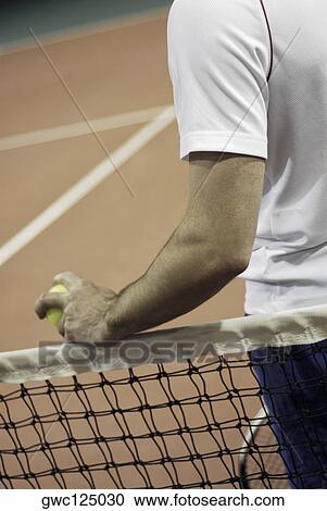 Mid section view of a man standing beside a tennis net View Large Photo Image Stock Image - Mid section view of a man standing beside a tennis net. Fotosearch