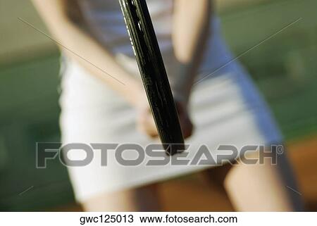Mid section view of a woman holding a tennis racket View Large Photo Image Stock Image - Mid section view of a woman holding a tennis racket. Fotosearch