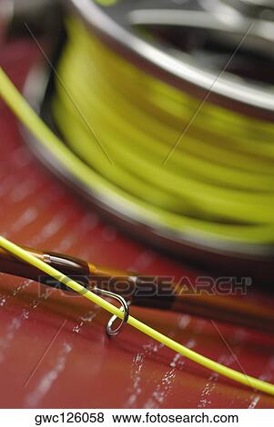Stock Photo - Close-up of a fishing reel and a fishing line. Fotosearch
