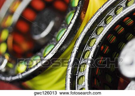 Stock Image - Close-up of two fishing reels. Fotosearch