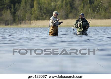 Two mature men fishing in the river View Large Photo Image Stock Photo - Two mature men fishing in the river. Fotosearch