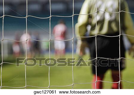 Close-up of a goalie standing in front of a goal post View Large Photo Image Stock Image - Close-up of a goalie standing in front of a goal post. Fotosearch