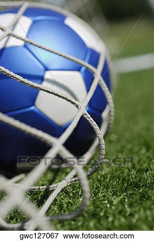 Stock Photo - Close-up of a soccer ball in a net. Fotosearch