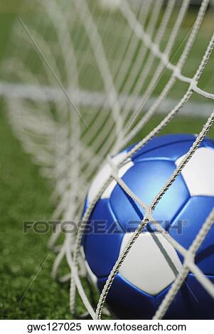 Stock Photography - Close-up of a soccer ball in a net. Fotosearch