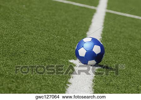 Picture - Close-up of a soccer ball placed on a yard line. Fotosearch