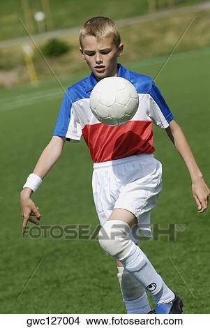 Close-up of a soccer player playing with a soccer ball View Large Photo Image Picture - Close-up of a soccer player playing with a soccer ball. Fotosearch