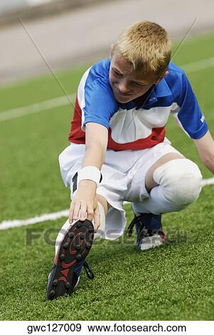 Close-up of a soccer player touching his toe with his hand View Large Photo Image Stock Photo - Close-up of a soccer player touching his toe with his hand. Fotosearch