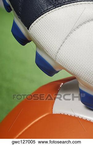 Stock Photography - Close-up of a soccer shoe and a soccer ball. Fotosearch
