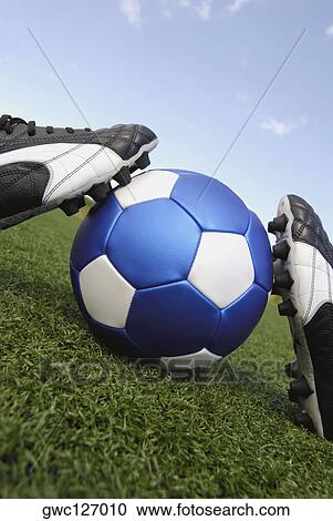 Close-up of soccer shoes and a soccer ball View Large Photo Image Stock Image - Close-up of soccer shoes and a soccer ball. Fotosearch
