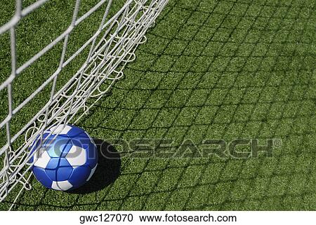 High angle view of a soccer ball near a net View Large Photo Image Stock Image - High angle view of a soccer ball near a net. Fotosearch