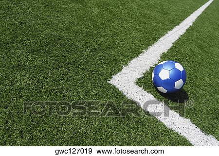 Stock Photo - High angle view of a soccer ball near a yard line. Fotosearch