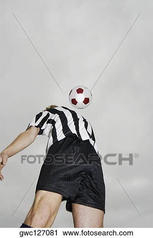 Low angle view of a soccer player heading a soccer ball View Large Photo Image Stock Image - Low angle view of a soccer player heading a soccer ball. Fotosearch
