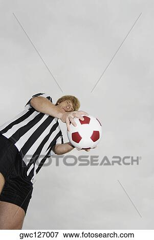 Low angle view of a soccer player holding a soccer ball View Large Photo Image Stock Photo - Low angle view of a soccer player holding a soccer ball. Fotosearch