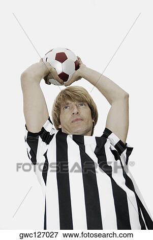Low angle view of a soccer player holding a soccer ball over his head View Large Photo Image Stock Photo - Low angle view of a soccer player holding a soccer ball over his head. Fotosearch