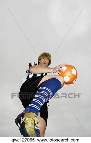Low angle view of a soccer player practicing View Large Photo Image Stock Photography - Low angle view of a soccer player practicing. Fotosearch