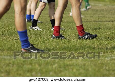 Low section view of a group of soccer players walking on a soccer field View Large Photo Image Stock Photo - Low section view of a group of soccer players walking on a soccer field. Fotosearch