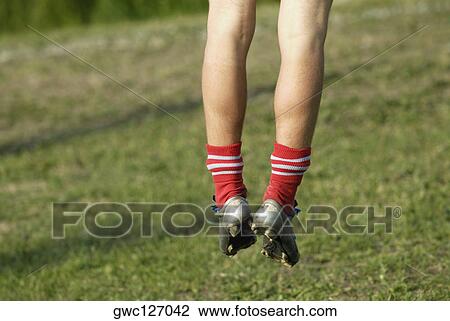 Low section view of a soccer player jumping View Large Photo Image Stock Image - Low section view of a soccer player jumping. Fotosearch