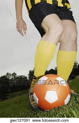 Low section view of a soccer player playing with a soccer ball View Large Photo Image Stock Image - Low section view of a soccer player playing with a soccer ball. Fotosearch