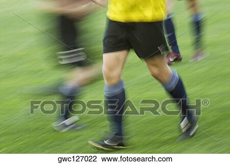 Low section view of two soccer players and a referee View Large Photo Image Stock Image - Low section view of two soccer players and a referee. Fotosearch