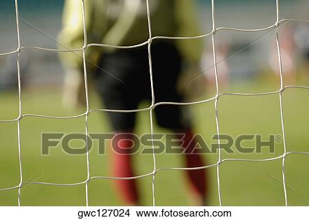 Mid section view of a goalie standing at the goal post View Large Photo Image Picture - Mid section view of a goalie standing at the goal post. Fotosearch