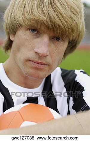 Portrait of a soccer player holding a soccer ball View Large Photo Image Stock Photo - Portrait of a soccer player holding a soccer ball. Fotosearch
