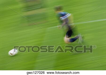 Side profile of a soccer player playing soccer in a soccer field View Large Photo Image Stock Photograph - Side profile of a soccer player playing soccer in a soccer field. Fotosearch
