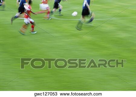 Soccer player playing soccer in a soccer field View Large Photo Image Stock Image - Soccer player playing soccer in a soccer field. Fotosearch