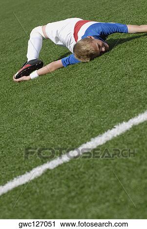 Soccer player stretching in a soccer field View Large Photo Image Stock Image - Soccer player stretching in a soccer field. Fotosearch