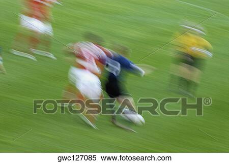 Soccer players playing soccer in a soccer field View Large Photo Image Stock Photography - Soccer players playing soccer in a soccer field. Fotosearch
