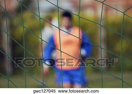 Two soccer players in front of a net View Large Photo Image Stock Photography - Two soccer players in front of a net. Fotosearch