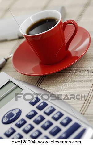 Close-up of a calculator and a cup of black tea View Large Photo Image Picture - Close-up of a calculator and a cup of black tea. Fotosearch