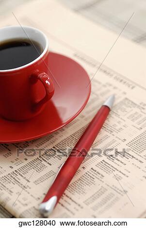 Close-up of a cup of black tea and pen on a newspaper View Large Photo Image Stock Image - Close-up of a cup of black tea and pen on a newspaper. Fotosearch