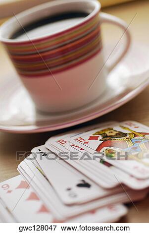 Close-up of a cup of black tea with playing cards View Large Photo Image Stock Photo - Close-up of a cup of black tea with playing cards. Fotosearch