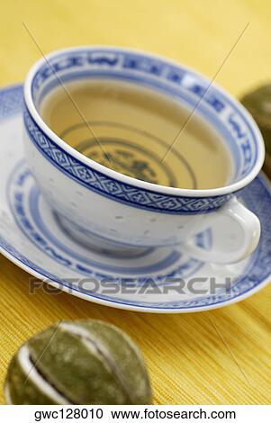 Close-up of a cup of herbal tea on a saucer View Large Photo Image Stock Image - Close-up of a cup of herbal tea on a saucer. Fotosearch